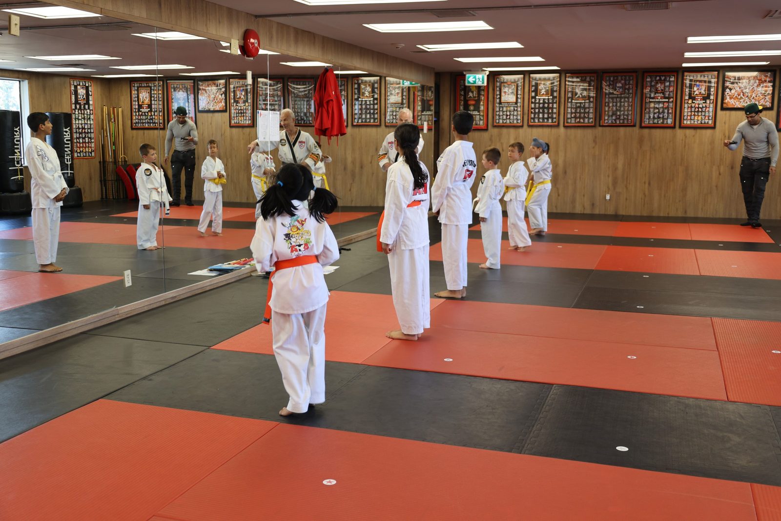 A kids taekwondo class lined up on the mats at Kingdom Athletics