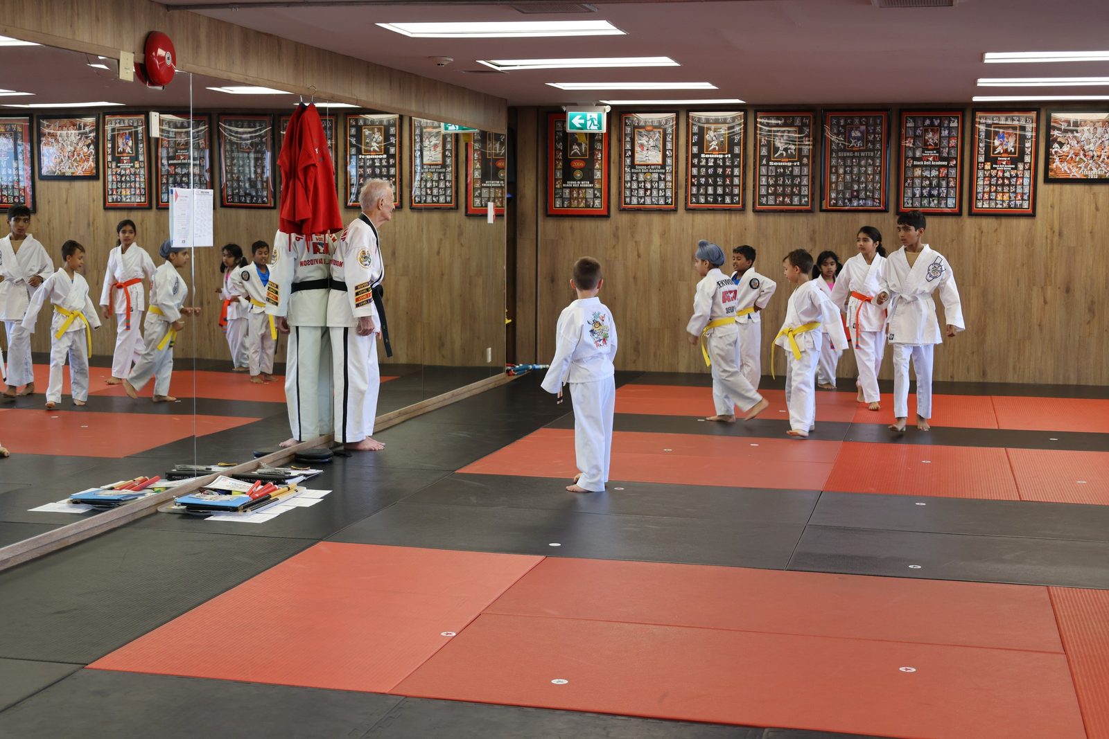 Young students in a taekwondo class on the mats, kids boxing classes white rock at Kingdom Athletics
