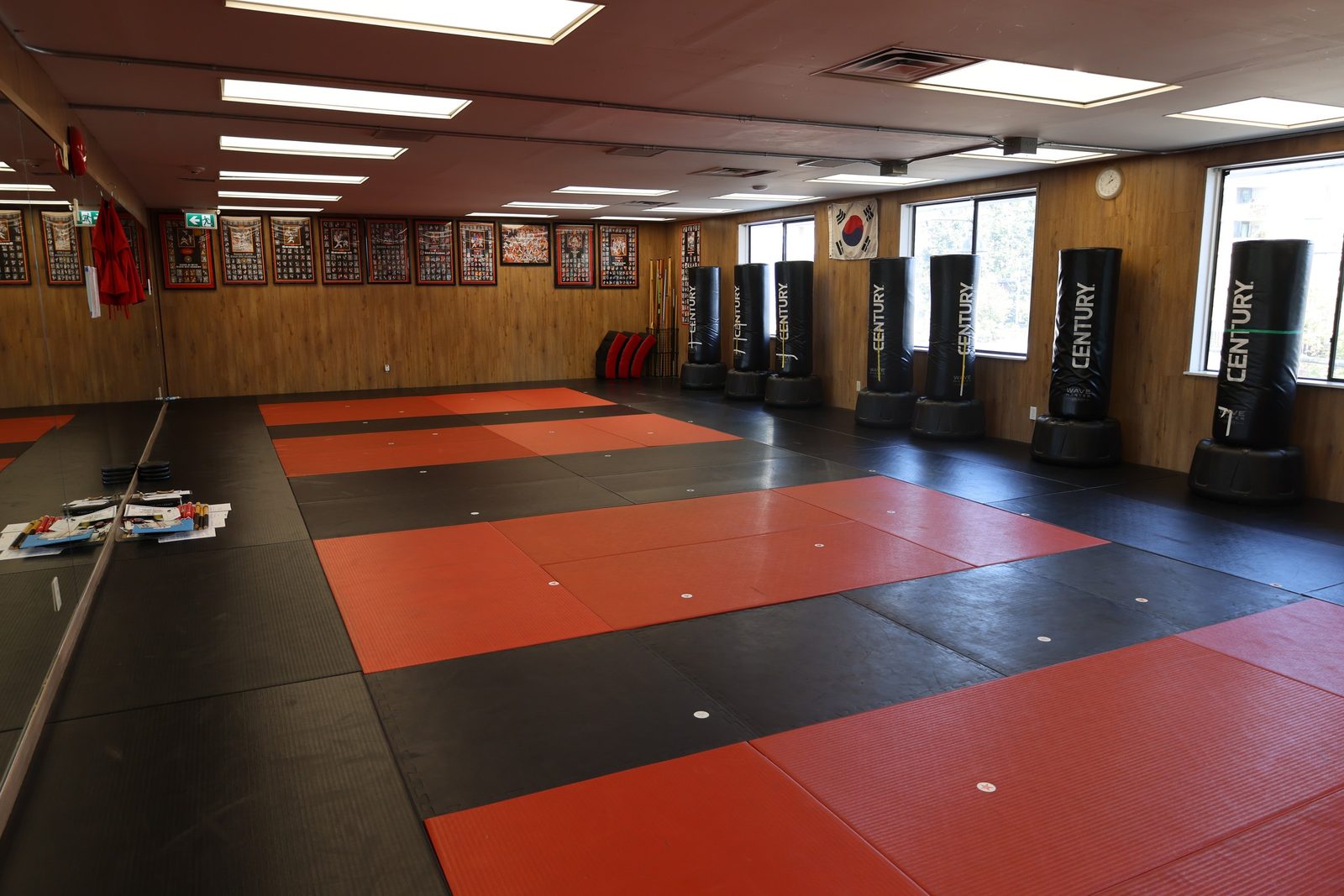 The martial arts training room with red and black mats at Kingdom Athletics