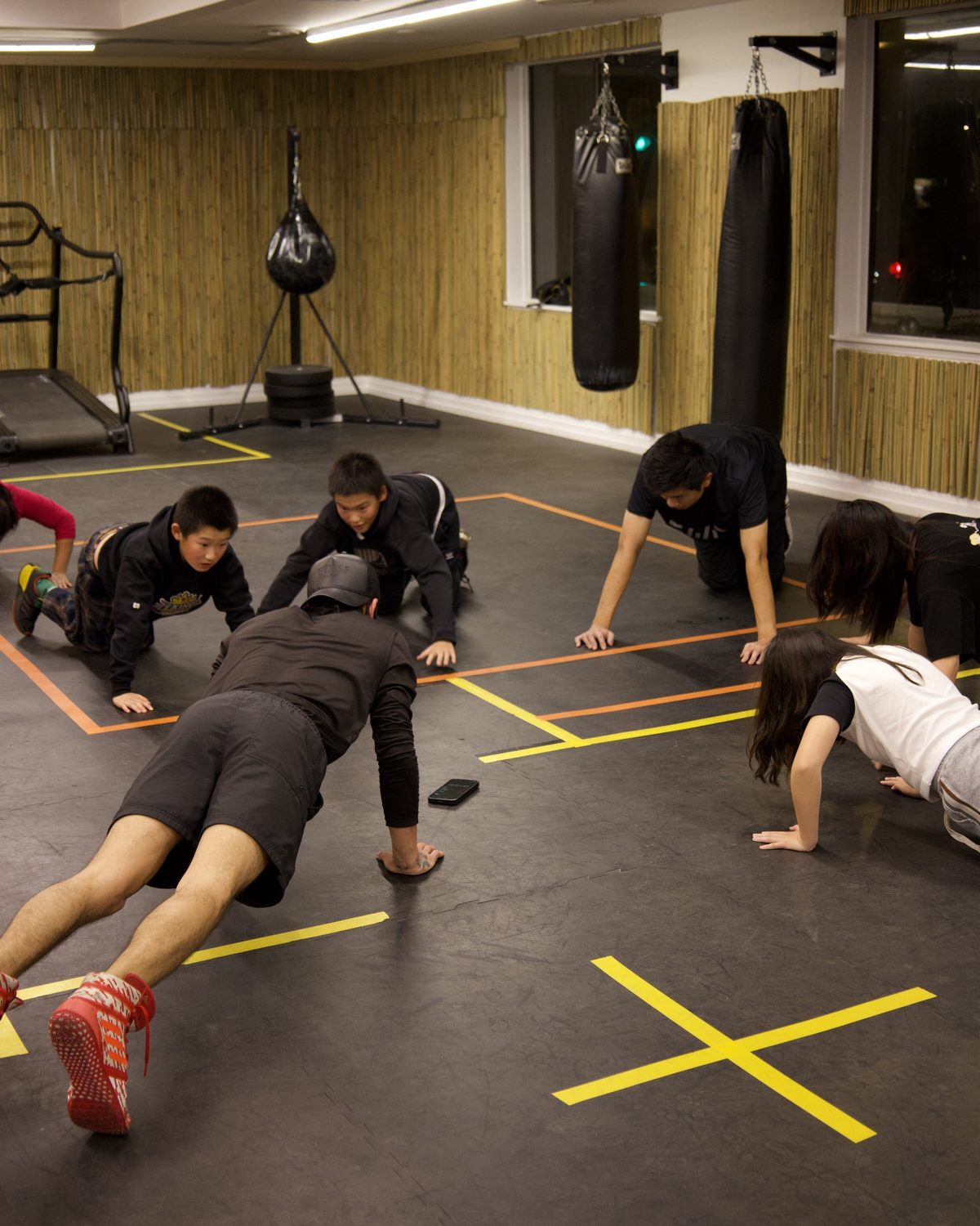A group doing core and bodyweight work on the gym floor at Kingdom Athletics